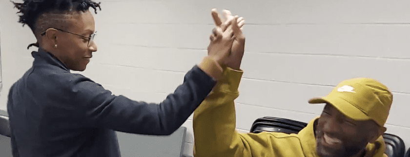 Two people joyfully giving a high-five.